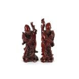 A pair of Chinese hardwood figures, of immortals, 21cm high
