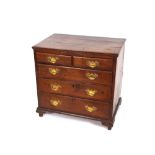 A Georgian oak chest, of small proportions fitted two short over three long drawers, having brass