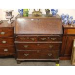 An 18th Century oak bureau, the fall front opening to reveal an interior arrangement of drawers