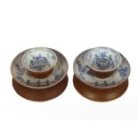 A pair of Chinese tea bowls and saucers, with Buddhist chicken decoration and brown under glaze