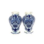 A pair of 18th Century Delft vases, of baluster form having floral decoration, 18cm high