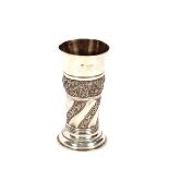 A late Victorian silver cylindrical vase, having raised foliate decoration and circular spread foot,