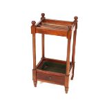 A Mahogany umbrella stand, raised on turned columns, 34cm