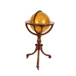 A celestial globe, by Newton & Berry raised on a turned baluster mahogany column and tripod base,