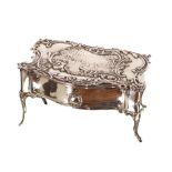 A silver jewellery box, in the form of a table the drawer sliding open to reveal blue velvet lined