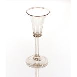 An antique wine glass, with bell shaped bowl raised on clear glass stem and circualr spread foot,