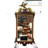 A 19th Century mahogany Chippendale style wall mirror, having fret carved frame, the gilded pediment