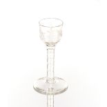 An antique wine glass, with foliate etched bowl and cotton twist stem on circular spread foot, 15cm