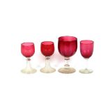 A pair of cranberry hock glasses, with clear glass ribbed columns and spread feet; and seven various