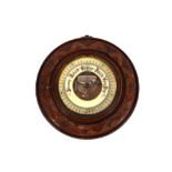 A late Victorian carved walnut circular barometer, 24cm dia.