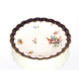 A set of five Royal Worcester shallow dishes, having lobed borders, painted floral spray