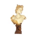 A large Art Nouveau glazed bust, of a maiden raised on an Egyptianesque plinth, signed Morin and