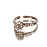 A white metal ring, set with a 1carat diamond and chip shoulders, 2.5gms total weight