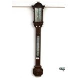 A Victorian carved oak cased stick barometer