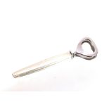 Georg Jensen, Denmark, a silver handled stainless steel bottle opener