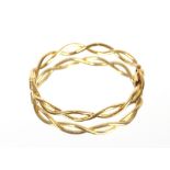 An 18ct gold snap bangle, of entwined design, approx. 17gms