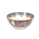 A large Chinese famille rose punch bowl, the exterior decorated panels of exotic interior and garden
