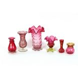 A cranberry tinted baluster vase, with frilled rim and clear glass leaf decorated base; a