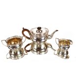 An Edwardian silver three piece tea set, with pierced foliate and gadrooned border  decoration,