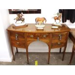 A mahogany and box wood strung bow fronted sideboard, central drawer above an arched frieze