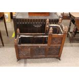 An antique carved oak cradle, with lozenge and foliate decorated panels bearing date 1651, 80cm