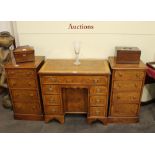 A pair of burr oak and cross banded bedside chest, fitted four graduated drawers raised on