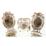 A small pair of Dresden porcelain easel mirrors, decorated cherubs and flowers; and a heart shaped