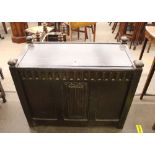 An antique carved oak coffer, the hinged lid above carved decoration and linen fold panel front,