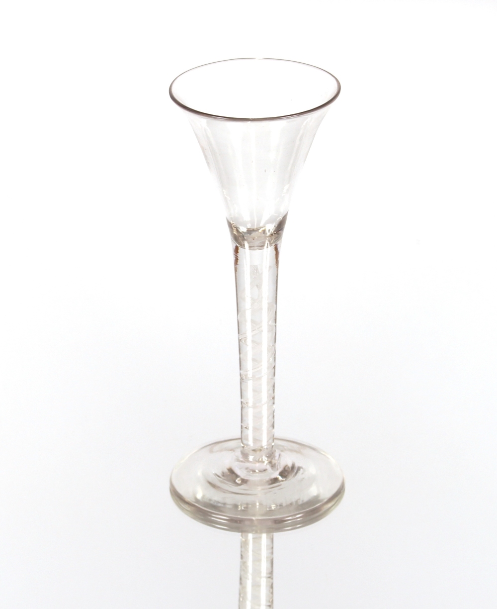 An antique wine glass, the tapering bowl on cotton twist spiral stem and circular spread foot,