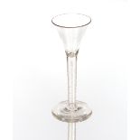 An antique wine glass, the tapering bowl on cotton twist spiral stem and circular spread foot,
