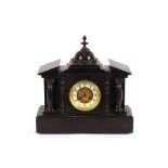 A late Victorian black slate mantel clock, of temple design, eight day movement striking on a