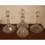 Four cut glass ships decanters, three with decanter labels "Whisky", "Sherry" and "Brandy"