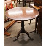 A Georgian mahogany circular occasional table, the birdcage top raised on a turned baluster column