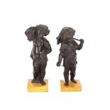 A pair of antique bronze cherub figures, raised on square marble plinths, 22cm high