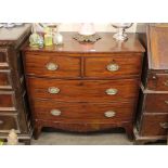 A Georgian mahogany bow front chest, of two short and two long drawers raised on shaped apron and