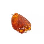 A large carved amber pendant, with yellow metal ring approx. 6cm x 4cm