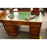 An Edwardian light oak pedestal desk, leather inset writing surface above three frieze drawers