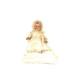 An Armand Marseille porcelain head doll, in lace trimmed Christening dress and bonnet