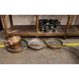 An antique copper frying pan, with brass handle; two others with iron loop handles; and a copper