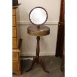 A Victorian mahogany shaving stand, with adjustable mirror, twin compartment top raised on turned