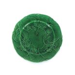Seven green Majolica "Lily" pattern plates, and two vine leaf pattern plates in dark and pale