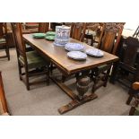 An oak draw leaf refectory dining table,  in the Jacobean manner raised on carved baluster cup and