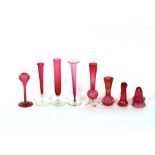 A collection of eight various cranberry and clear glass posy vases, including one with gilt enamel