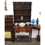 A 19th Century oak dresser of small proportions, with shelved and boarded back, three long drawers
