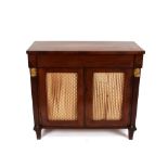 A Regency mahogany side cabinet, fitted blind frieze drawer above shelves enclosed by pair of