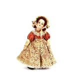 A small French porcelain headed doll, dressed in lace trimmed dress and bonnet on stand, 25,5cm
