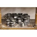 A quantity of various antique pewter baluster measures, and various straight sided ale mugs