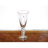 A large glass goblet, of tapering form on twist stem and circular spread foot, 27.5cm high