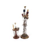 A plated hat pin stand; and a small wooden hat pin stand and contents of various decorative hat