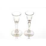 An antique wine glass, the bell shaped bowl raised on baluster stem and circular spread foot, 14cm